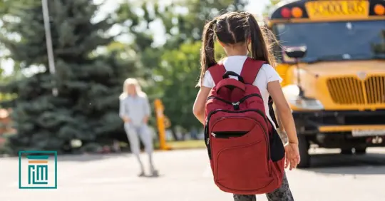 child waiting outside a school
