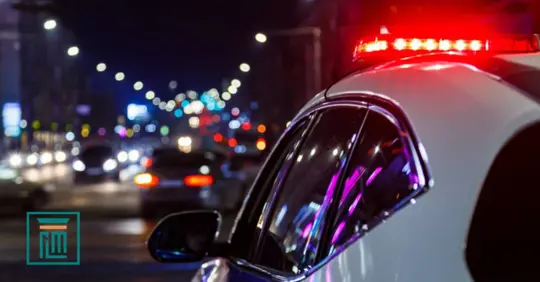 police car driving at night