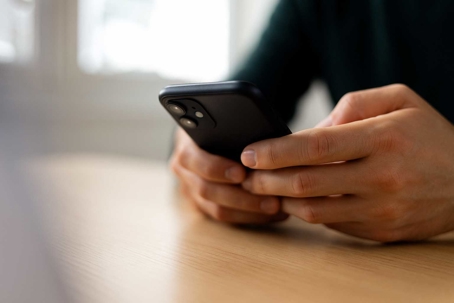 hands holding a cell phone